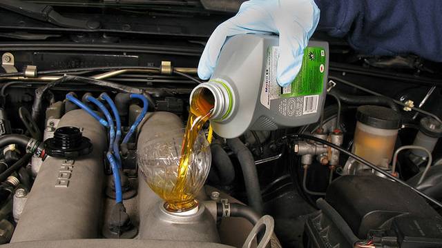 Engine oil being poured into a car