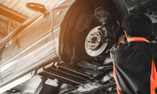 mechanic fixing vehicle brake pads