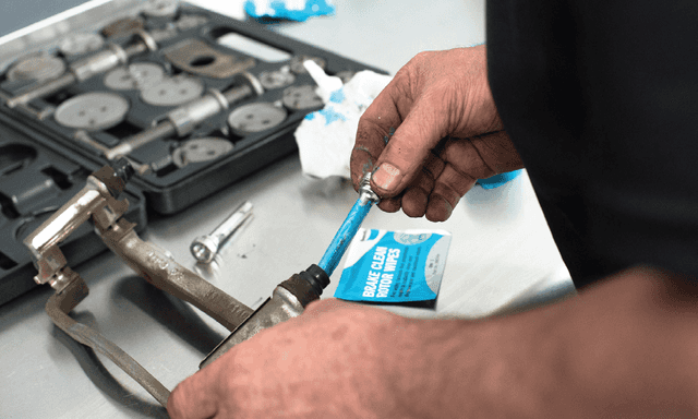 Mechanic repairing brake pads